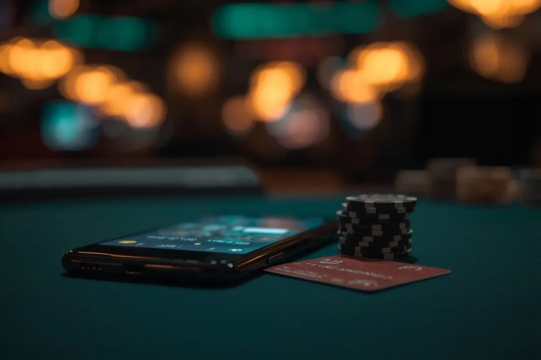 Phone with a casino game, bank card and chips
